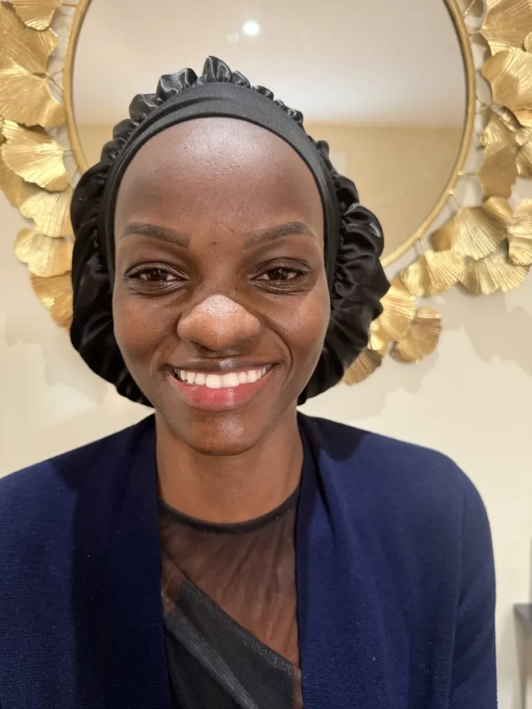 Smiling client in a black satin bonnet showing defined Nano Brows at Vivi Brows & Head Spa in London, Ontario